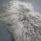 Long-haired Icelandic sheepskin rug in a linen grey colour with a natural, shaggy texture.