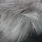 Close-up of a linen grey Icelandic sheepskin rug with long, thick, natural wool fibres.