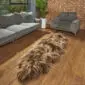 INRD Long double Icelandic sheepskin rug with thick, shaggy rusty brown and grey wool on a wooden floor.