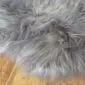 Close-up of a grey Icelandic sheepskin rug with long, thick wool fibres.