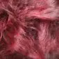 Close-up of long, shaggy burgundy red Icelandic sheepskin wool texture.