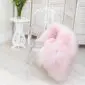 Long-haired pale pink Icelandic sheepskin rug laid flat.