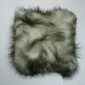 Long-haired Icelandic sheepskin cushion with cream wool and dark grey tips.