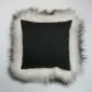 Square black cushion with a long, shaggy white Icelandic sheepskin trim.