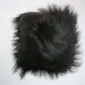 Square black Icelandic sheepskin cushion with long, shaggy wool texture .