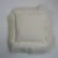 Rectangular ivory Icelandic sheepskin cushion with long, shaggy wool trim.