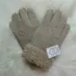Pair of dark beige suede sheepskin gloves with thick woolly cuffs.
