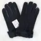 A pair of black suede sheepskin gloves with visible stitching and a white brand label.