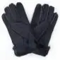 A pair of black suede sheepskin gloves with visible stitching and folded cuffs .
