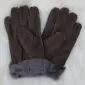 A pair of dark brown suede sheepskin gloves with grey wool lining visible at the cuffs.