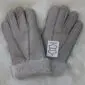 A pair of grey suede sheepskin gloves with visible stitching and thick wool-lined cuffs.