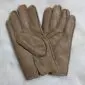 A pair of light brown sheepskin nappa leather gloves with visible stitching and textured palms.
