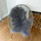 Mongolian Lambskin Steel- Steel grey Mongolian lambskin rug with long, curly wool laid flat.