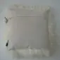 Reverse side of an ivory Mongolian sheepskin cushion showing a smooth fabric backing and zip closure.