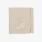 Folded beige merino wool kids blanket featuring a white embroidered sheep and stars design.
