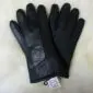 A pair of black sheepskin leather gloves with visible stitching and a small white tag at the wrist.