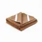 Folded brown camel and merino wool mattress topper with white elastic corner straps.