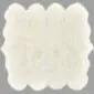 Large ivory octo sheepskin rug with a thick wool pile and a natural scalloped edge.