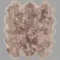 Large, multi-pelt sheepskin rug in mottled shades of brown and cream with a thick, woolly texture.