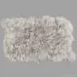 Large rectangular linen-coloured Icelandic sheepskin rug with long, wavy wool and natural scalloped edges.
