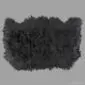 A large, black Icelandic sheepskin rug with long, thick wool and a natural, irregular triple-skin shape.