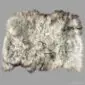 Long-haired Icelandic sheepskin rug in natural light grey and cream tones with a textured, wavy fleece.