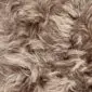 Close-up of taupe Icelandic sheepskin rug showing long, wavy natural wool fibres.