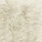Close-up of a cream British sheepskin rug with long, thick, natural wool fibres.
