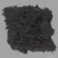 A rectangular black Icelandic sheepskin rug with long, thick, shaggy wool and natural uneven edges.