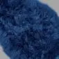 Close-up of a navy blue double sheepskin rug with thick, textured wool pile.