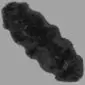 A long, double-length black sheepskin rug with a thick, textured wool pile and natural curved edges.