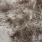 Close-up of a Paco sheepskin rug featuring long, thick wool in mottled shades of grey, brown, and cream.