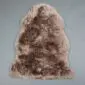 Natural shaped sheepskin rug with thick, textured wool in mottled shades of brown and cream.