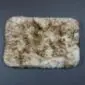 Rectangular small sheepskin pet rug with thick cream and brown wool pile.