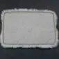 Underside of a rectangular grey sheepskin pet rug with quilted stitching and a non-slip backing.