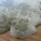 Large vole grey sexto sheepskin rug with a thick, textured pile and natural scalloped edges.
