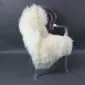 Large natural cream sheepskin rug with long, thick wool laid flat.