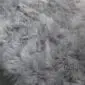 Close-up of a steel grey sheepskin rug with long, thick, textured wool fibres.