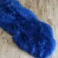 Long navy blue double sheepskin rug with thick, textured wool pile.