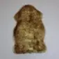 Natural shaped sheepskin pet rug with thick, textured brown and cream wool.