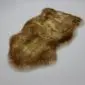 Natural shape sheepskin pet rug in mottled brown and tan tones with a thick, textured wool pile.