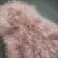 Long-pile Icelandic sheepskin rug in pale pink with a natural, shaggy texture.