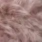 Close-up of a pale pink Icelandic sheepskin rug with long, wavy wool fibres.