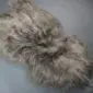 Long-haired taupe Icelandic sheepskin rug with natural wavy texture.
