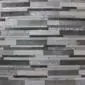 Patchwork cowhide rug featuring horizontal stripes in varying shades of silver, grey, and charcoal.