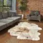 Hide Rugs_Lifestyle_0210 Large multi-layered Icelandic sheepskin rug with long, textured wool in cream, grey, and brown tones on a wooden floor.