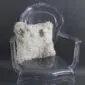 Square cream Tibetan sheepskin cushion with long, curly wool texture resting on a .