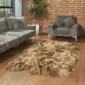 IDR4S Large rusty brown and cream Icelandic sheepskin rug with long, shaggy wool on a wooden floor.