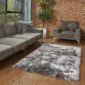 Rectangular grey and white Icelandic shorn sheepskin rug with straight edges on a wooden floor.