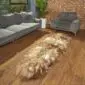 Long double Icelandic sheepskin rug with thick, shaggy wool in natural rusty grey and cream tones.